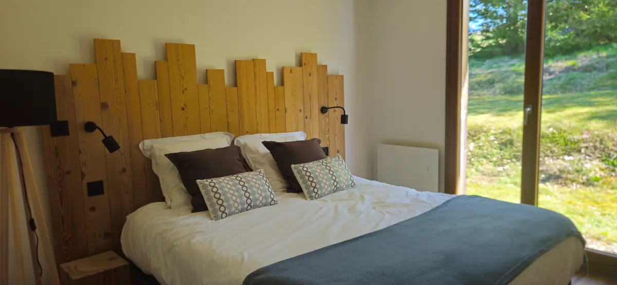 Chambre 2 avec tête de lit en bois découpé en ligne de crête